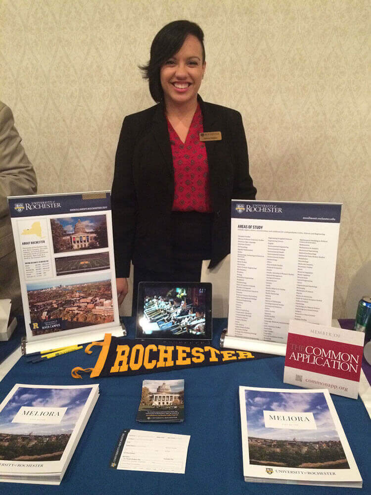 Staff member at the University of Rochester's College Fair table