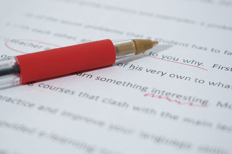 red pen ontop of an essay that had been edited