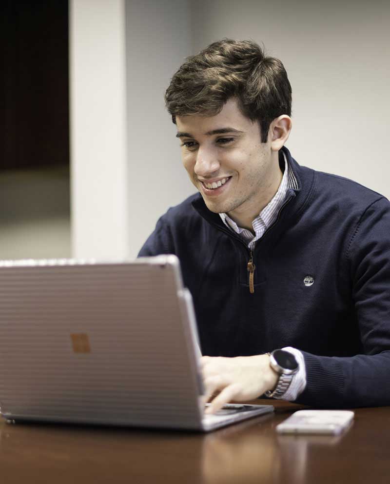 student studying on a laptop
