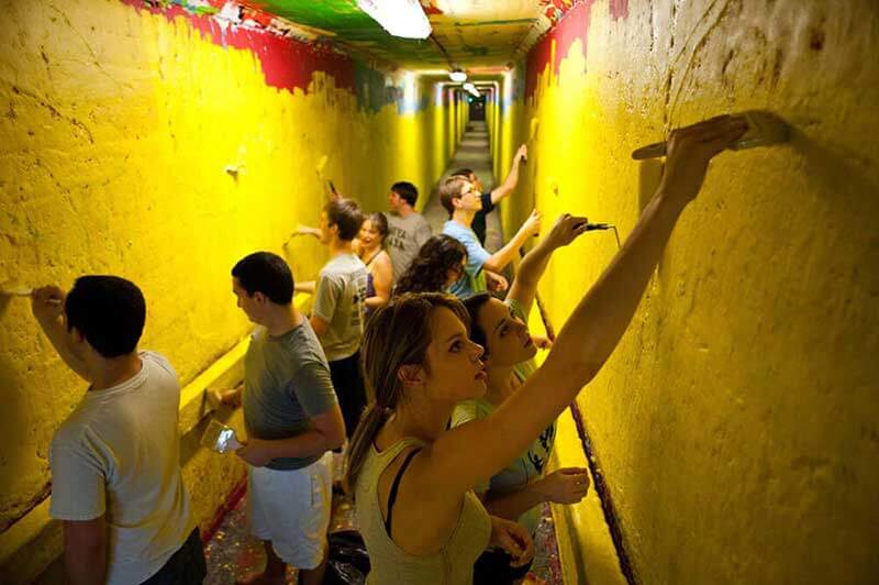 Students painting one of the tunnels under campus